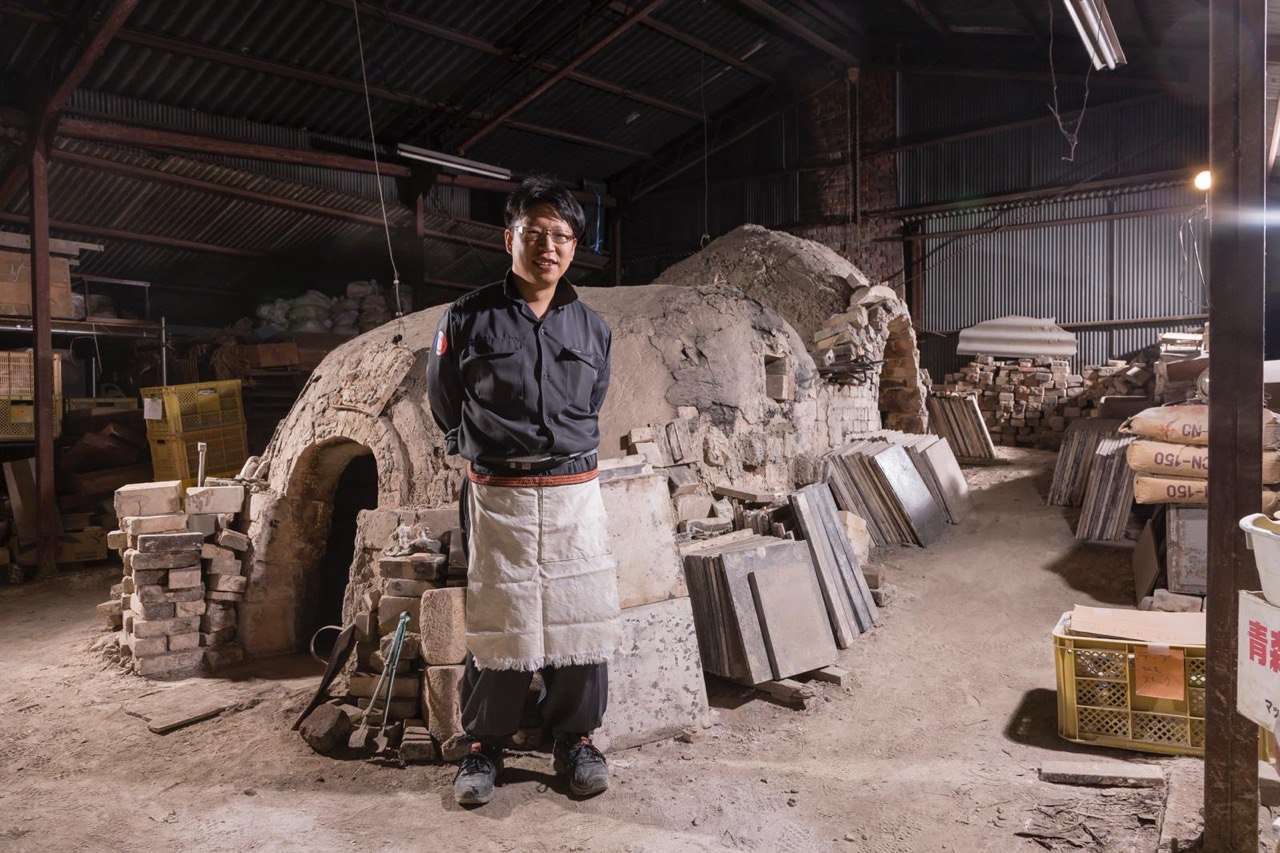 Taiga Mori standing in front of a wood-fired kiln in Bizen.