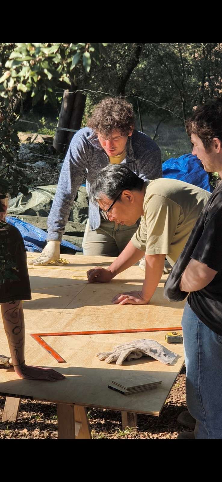 The building team marking out Kujiragama's template on a wooden board at Can Brull.