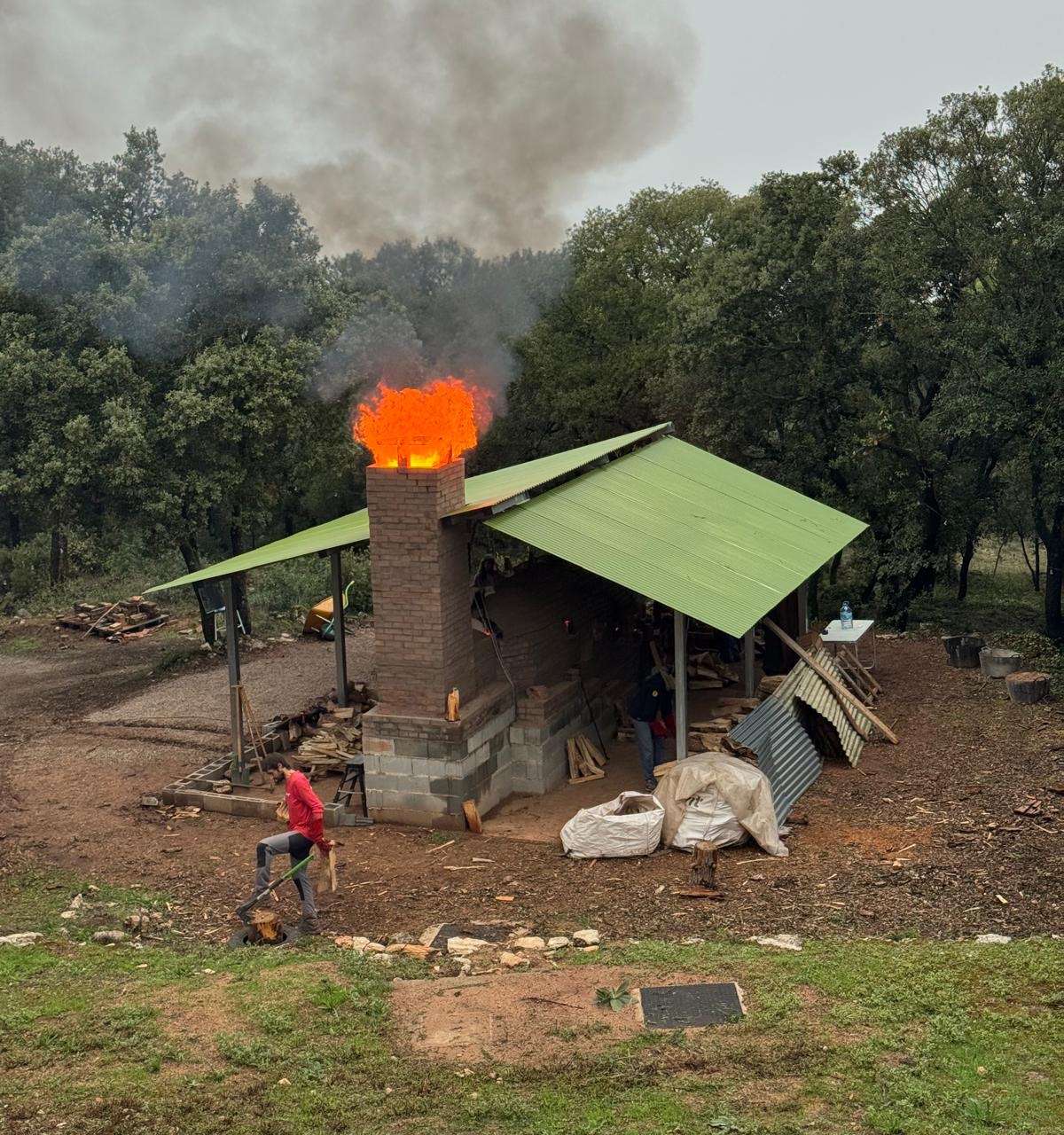 Smoke rising from the chimney of Kujiragama in the Montseny landscape