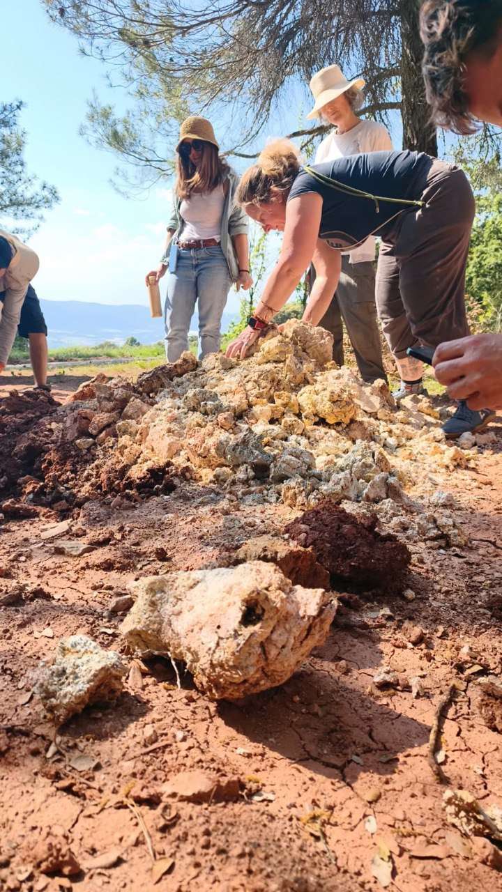People collecting and observing wild clay in the landscape around Can Brull.
